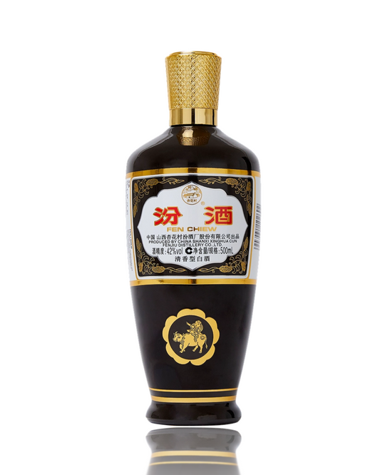 Black bottle with gold accents and a white label on a white background