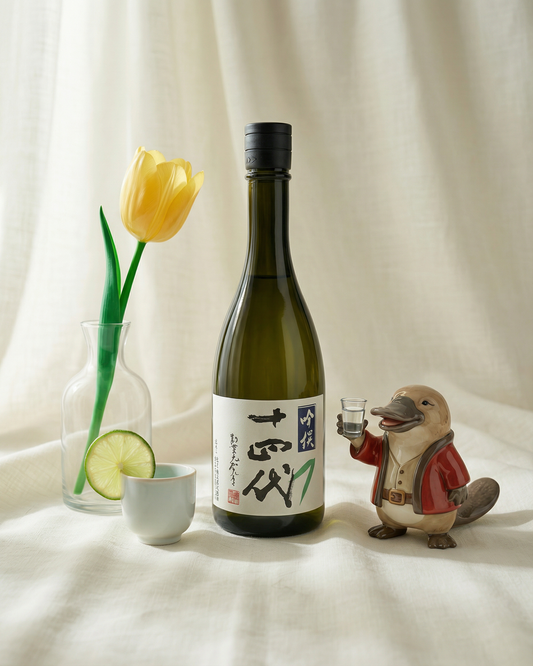 A glass of chilled Juyondai Ginsen Ginjo sake paired with sashimi, available for regional QLD and NSW delivery